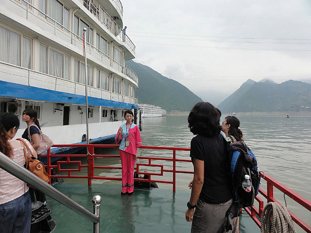 Tujia guide in her traditional dress waves goodbye