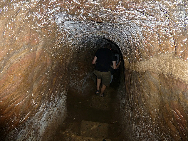 Excavated with hand tools, it is dark and narrow