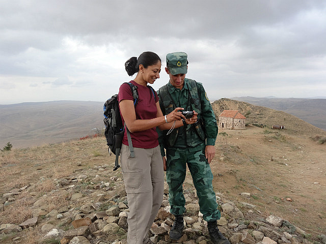 Azerbaijani border guard viewing photos from Sheki