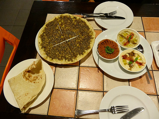 Manaesh with accompanying condiments