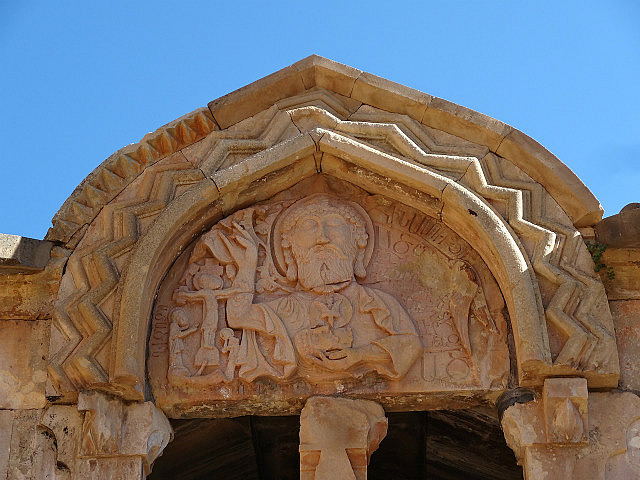 Relief carving depicting Jesus holding a tablet