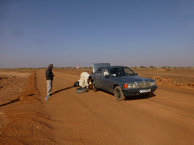 Swapping out a flat tire in the middle of the road