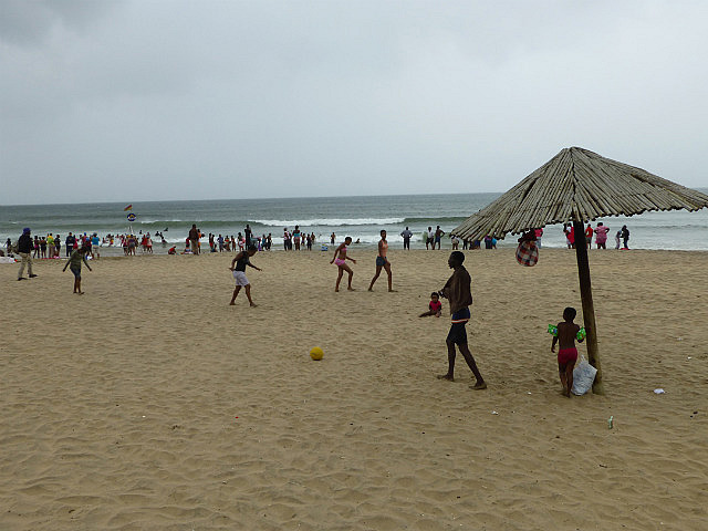 People enjoying the beach despite imminent rain