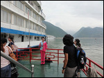 Tujia guide in her traditional dress waves goodbye