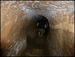 Excavated with hand tools, it is dark and narrow