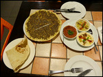 Manaesh with accompanying condiments