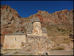 Noravank monastery set against red rock cliffs