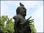 Expressive Seville statue with feathers in his cap