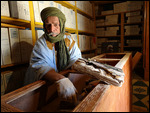 Saif showing one of the ancient manuscripts 
