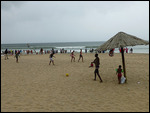 People enjoying the beach despite imminent rain