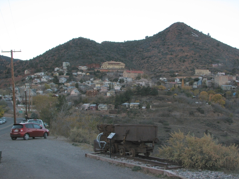 IMG_0827.JPG - Equipment from copper mining on display on the street. Notice the large monogram J on the side of the hill.
