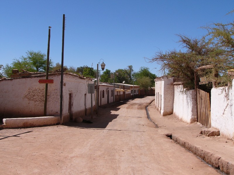 P1080134.JPG - Another deserted street with waste water flowing down the gutter. The streets have been treated with vichufita, a product derived from salt, which allows them to retain the original look of the Spanish colonial era.