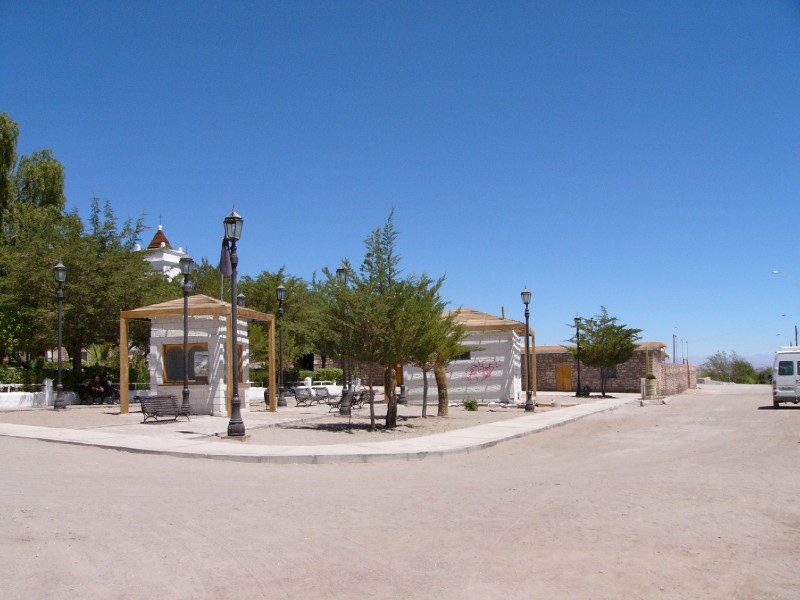 P1080343.JPG - Toconao Plaza on a quiet Monday afternoon. This village  (38 km. from San Pedro)  is at 2475m above sea level. It is an oasis, whose sweet waters, free of arsenic, allow for the cultivation of a variety of fruit trees such as pears, plums, quince and grapes as well as a large amount of vegetables. This pre-Hispanic settlement has an interesting architecture in local liparita stone, which is volcanic soft and white stone, extracted from a quarry 2 km. up the local street. 