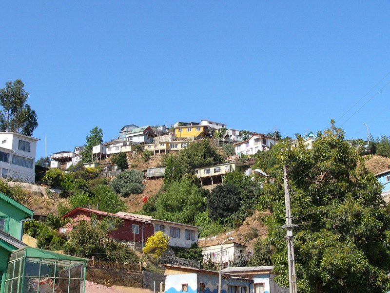 P1090370.JPG - Homes perched precariously on the hillside. Unlike hilly cities in the US, it is the poorer folk that live on the hill.