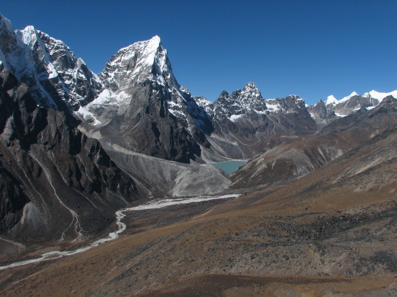 IMG_8205.JPG - Same view panned to the right. Tawoche has disappeared at left, but the Lobutse peaks can be seenin the distance. Also seen is Chola Pass (the snowy path between the mountains near the right edge of the pic)
