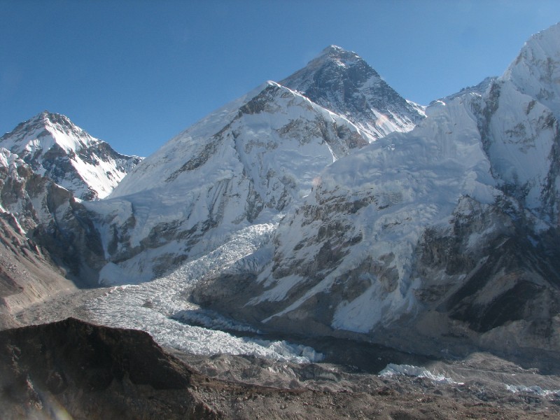IMG_8304.JPG - At the top of Kala Patthar (5649m/18530 ft.). Everest and the Khumbu Icefall. Changtse is at the left edge over the Lho La pass. The Lho La pass is significant becuase of the historical association with George Mallory. This is the pass which George Mallory climbed from the Tibetan side in 1922 and pronounced the Khumbu Icefall "unclimbable". He said this with relief as Nepal was out of bounds to foreigners before WWII