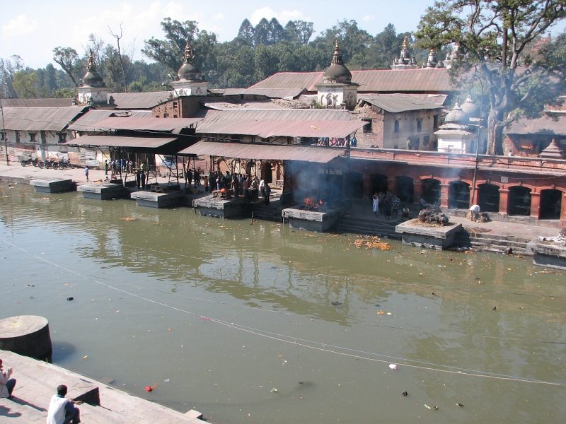 IMG_8442.JPG - The Bagmati is a holy river and like Varanasi on the Ganges, Pashupatinath is a popular place to be cremated. The burning ghats (Arya ghats) immediately in front of the temple are for royalty. Recently ten members of the royal family were cremated here after the infamous massacre of 2001 in which both King Birendra and Queen Aishwarya were gunned down by their son. The cremation ghats seen here are for the common people.